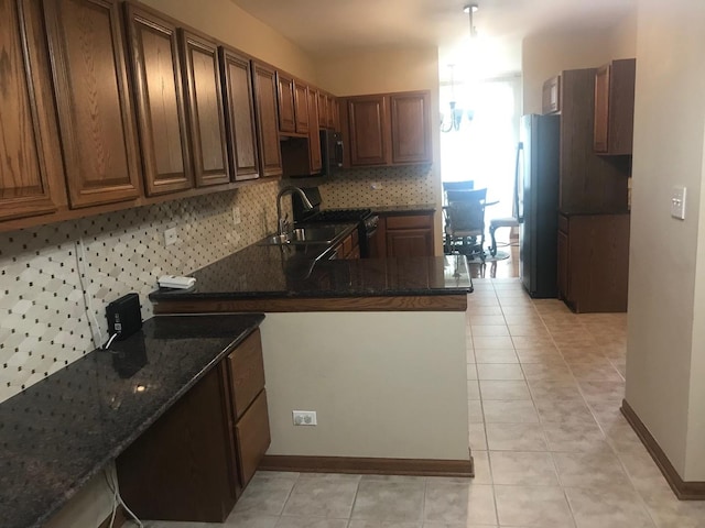 1317 Leonard Dr, Schaumburg, IL 60193 - kitchen featuring appliances with stainless steel finishes, backsplash, dark stone countertops, and light tile patterned floors