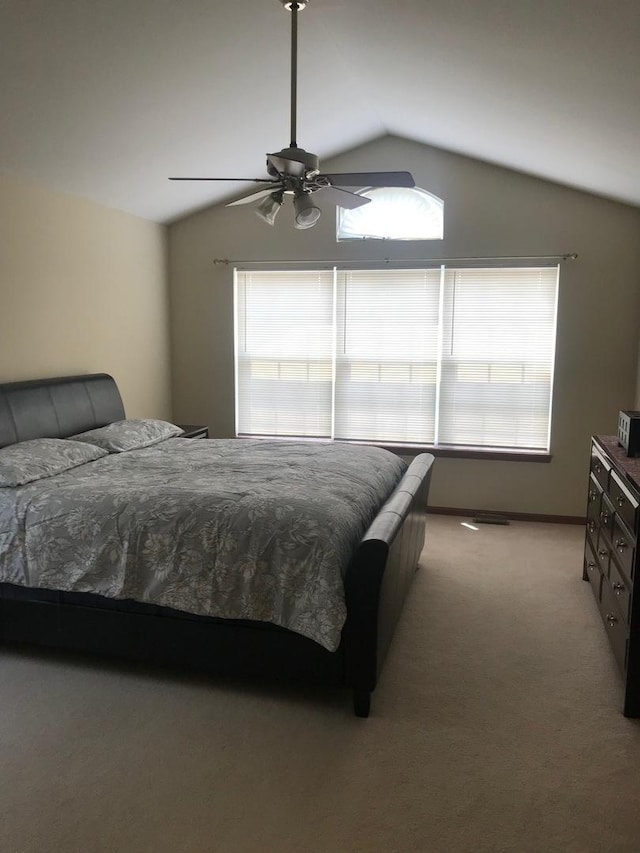 1317 Leonard Dr, Schaumburg, IL 60193 - bedroom featuring multiple windows, vaulted ceiling, light carpet, and ceiling fan