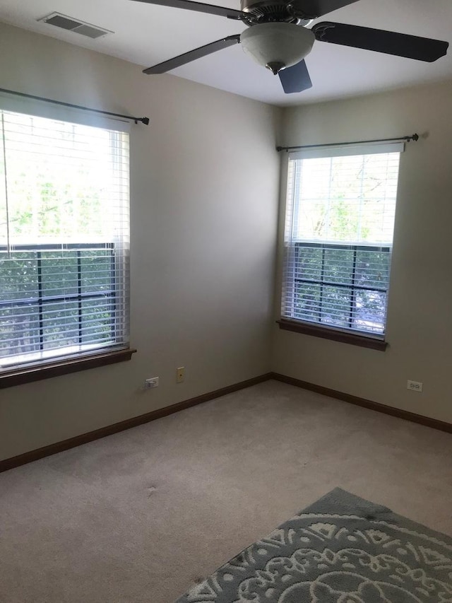 1317 Leonard Dr, Schaumburg, IL 60193 - spare room featuring carpet and a ceiling fan