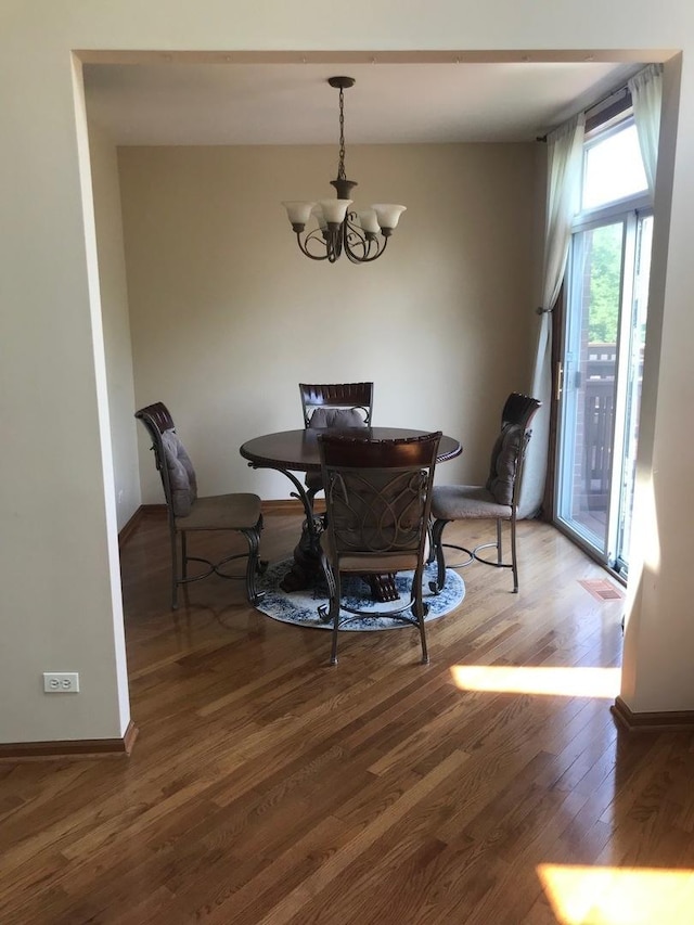 1317 Leonard Dr, Schaumburg, IL 60193 - dining room with a chandelier and wood finished floors