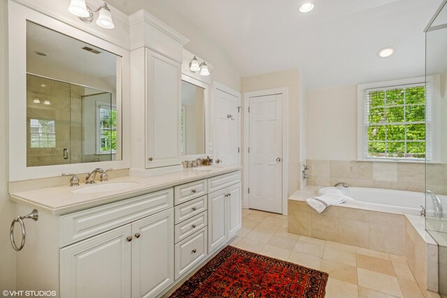 3233 Park Pl, Evanston, IL 60201 - full bathroom with double vanity, tile patterned floors, a bath, tiled shower, and recessed lighting