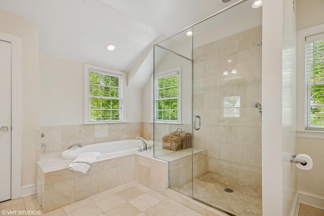 3233 Park Pl, Evanston, IL 60201 - bathroom with a bath, a shower stall, plenty of natural light, vaulted ceiling, and tile patterned flooring