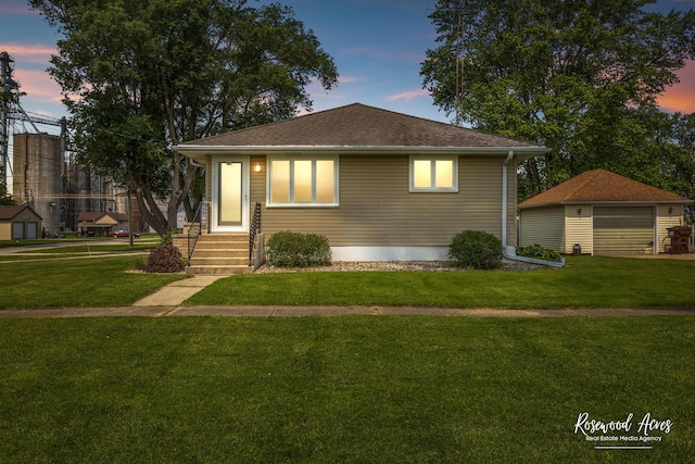 301 N Second St, Ashkum, IL 60911 - view of front of house featuring a front lawn, a detached garage, and an outdoor structure