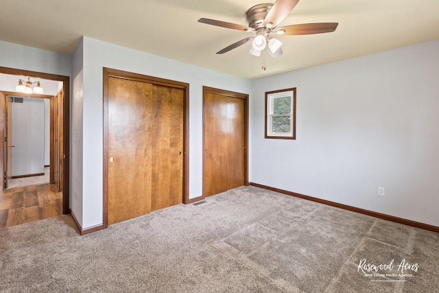 301 N Second St, Ashkum, IL 60911 - unfurnished bedroom featuring multiple closets, carpet floors, and ceiling fan