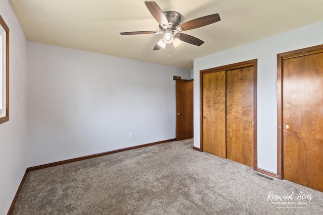 301 N Second St, Ashkum, IL 60911 - unfurnished bedroom with carpet floors, ceiling fan, and two closets