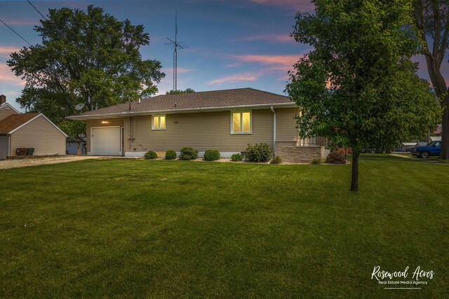 301 N Second St, Ashkum, IL 60911 - ranch-style home with an attached garage, a front lawn, driveway, and a shingled roof