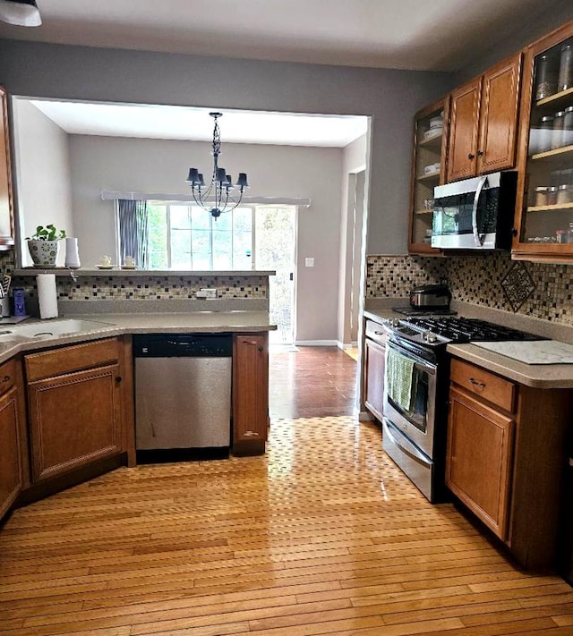 20 Lily Ct, Bolingbrook, IL 60440 - kitchen with stainless steel appliances, light wood-style floors, a chandelier, and backsplash