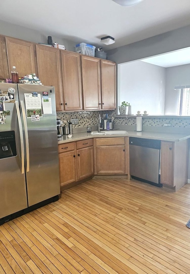 20 Lily Ct, Bolingbrook, IL 60440 - kitchen featuring appliances with stainless steel finishes, light wood-style floors, light countertops, and backsplash