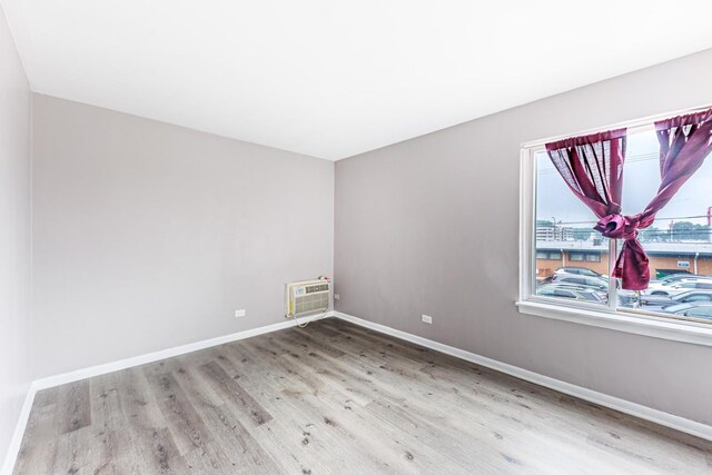 9516 S Kildare Ave Unit 2N, Oak Lawn, IL 60453 - unfurnished room featuring wood finished floors and a wall unit AC