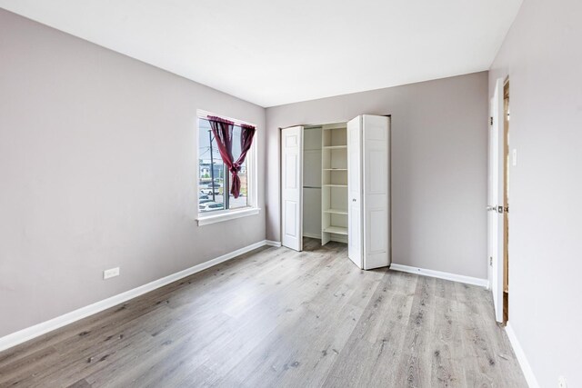 9516 S Kildare Ave Unit 2N, Oak Lawn, IL 60453 - unfurnished bedroom featuring light wood finished floors and a closet