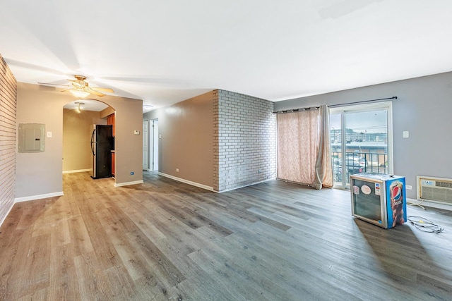 9516 S Kildare Ave Unit 2N, Oak Lawn, IL 60453 - unfurnished living room with electric panel, ceiling fan, wood finished floors, brick wall, and arched walkways