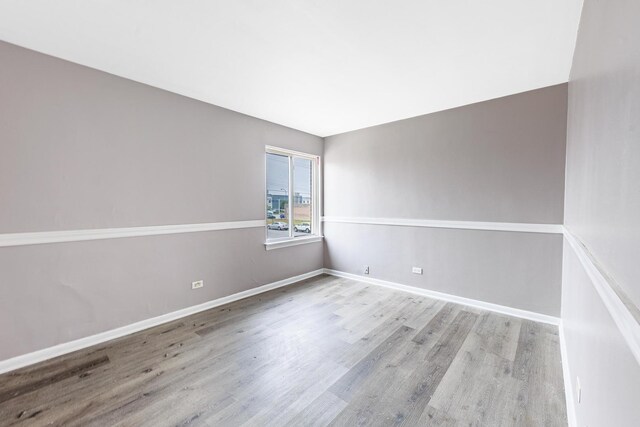 9516 S Kildare Ave Unit 2N, Oak Lawn, IL 60453 - empty room with wood finished floors and baseboards