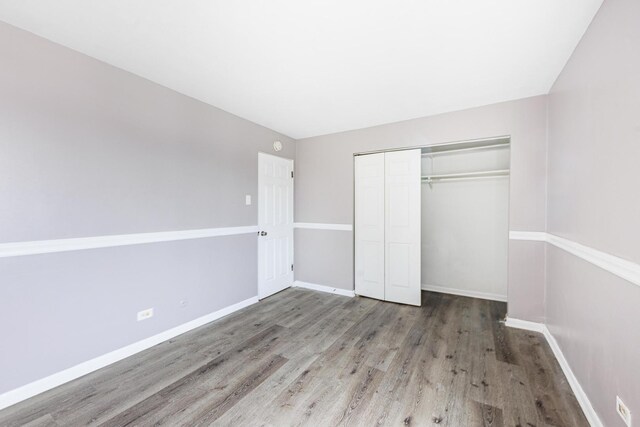 9516 S Kildare Ave Unit 2N, Oak Lawn, IL 60453 - unfurnished bedroom with wood finished floors and a closet