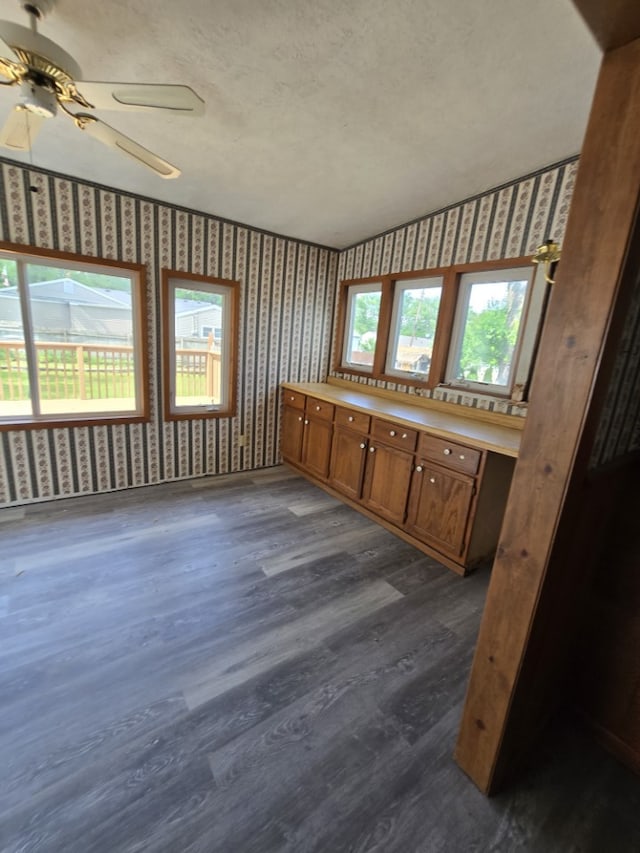 1406 Searle Dr, Normal, IL 61761 - unfurnished room with wallpapered walls, dark wood-style floors, and ceiling fan