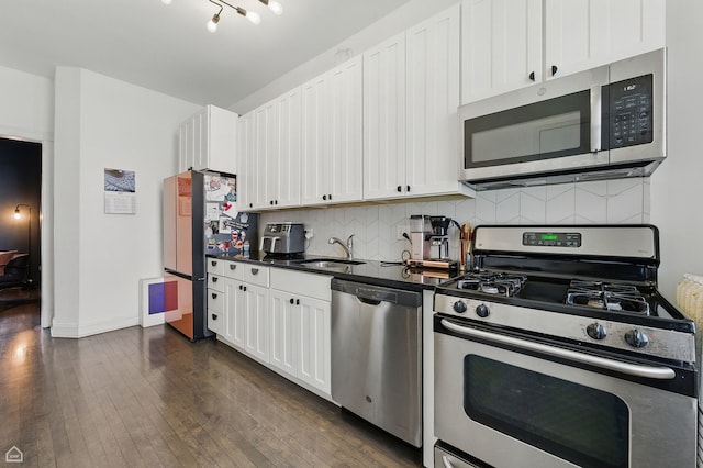 726 W Sheridan Rd Unit 3S, Chicago, IL 60613 - kitchen featuring appliances with stainless steel finishes, dark countertops, backsplash, dark wood-style flooring, and white cabinets