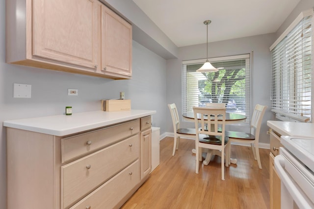 221 Pin Oak Dr, Wilmette, IL 60091 - kitchen with light brown cabinetry, light wood-style floors, light countertops, and pendant lighting
