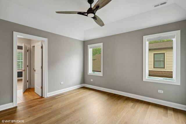 411 S Berkley Ave, Elmhurst, IL 60126 - unfurnished bedroom with light wood-type flooring, multiple windows, and a ceiling fan