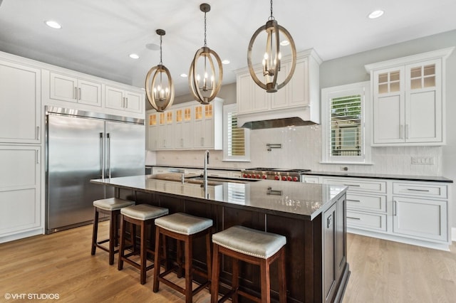 411 S Berkley Ave, Elmhurst, IL 60126 - kitchen with built in refrigerator, decorative backsplash, white cabinetry, glass insert cabinets, and recessed lighting