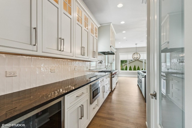 411 S Berkley Ave, Elmhurst, IL 60126 - kitchen featuring beverage cooler, appliances with stainless steel finishes, dark wood finished floors, backsplash, and glass insert cabinets