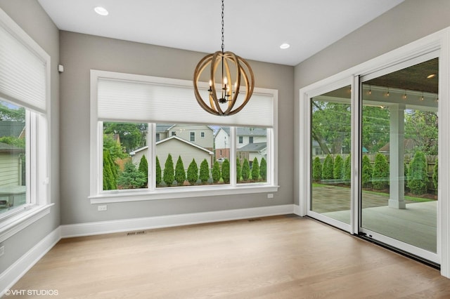 411 S Berkley Ave, Elmhurst, IL 60126 - unfurnished dining area featuring a chandelier, healthy amount of natural light, wood finished floors, and recessed lighting