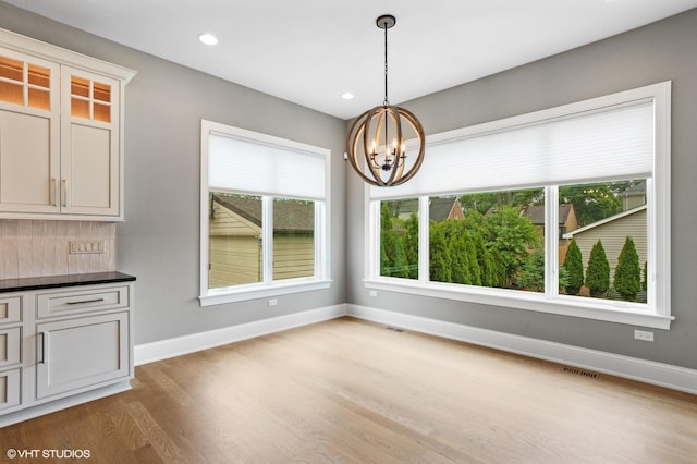 411 S Berkley Ave, Elmhurst, IL 60126 - unfurnished dining area featuring light wood finished floors, a chandelier, and recessed lighting