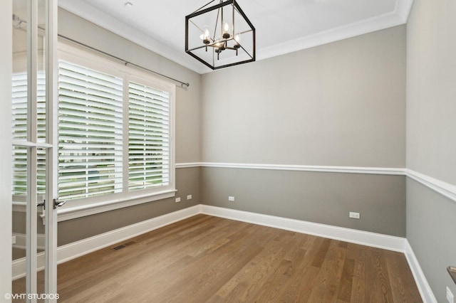 411 S Berkley Ave, Elmhurst, IL 60126 - empty room with wood finished floors, a chandelier, and ornamental molding
