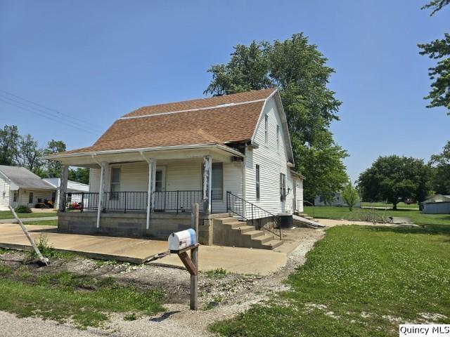 200 S Gillham, West Point, IL 62380 - view of front of property with covered porch, a front lawn, and a shingled roof