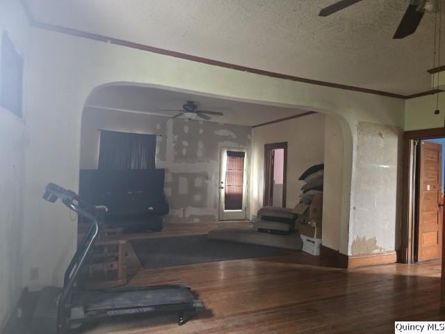 200 S Gillham, West Point, IL 62380 - living room with ceiling fan, arched walkways, a textured ceiling, wood finished floors, and crown molding