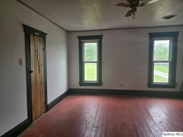 200 S Gillham, West Point, IL 62380 - empty room featuring hardwood / wood-style floors, plenty of natural light, and ceiling fan