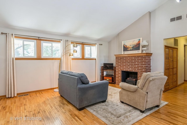 812 S Center St, Plano, IL 60545 - living area with wood-type flooring, a fireplace, and high vaulted ceiling