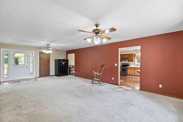 43 Coffman Ln, Plano, IL 60545 - living room with ceiling fan, plenty of natural light, and light carpet