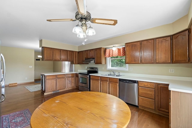 43 Coffman Ln, Plano, IL 60545 - kitchen with appliances with stainless steel finishes, under cabinet range hood, dark wood-type flooring, and light countertops