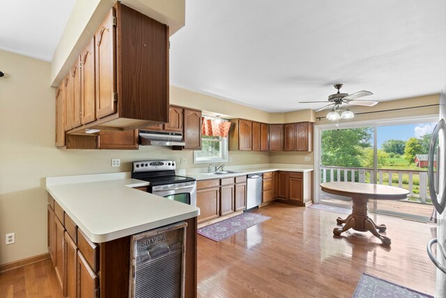 43 Coffman Ln, Plano, IL 60545 - kitchen featuring under cabinet range hood, stainless steel appliances, beverage cooler, light countertops, and a ceiling fan