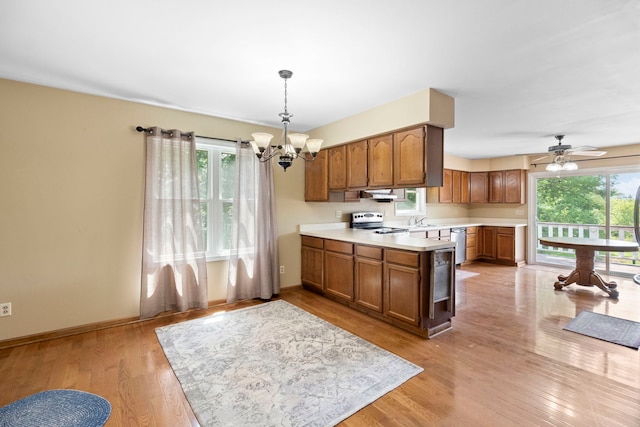 43 Coffman Ln, Plano, IL 60545 - kitchen with appliances with stainless steel finishes, a chandelier, light countertops, brown cabinets, and light wood-type flooring