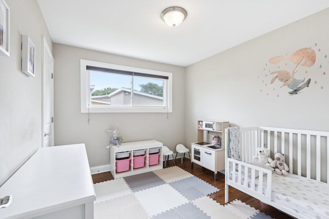 9333 Kildare Ave, Skokie, IL 60076 - bedroom with dark wood-style floors and a crib