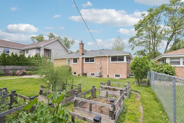 9333 Kildare Ave, Skokie, IL 60076 - back of house with a vegetable garden, a chimney, brick siding, and a fenced backyard