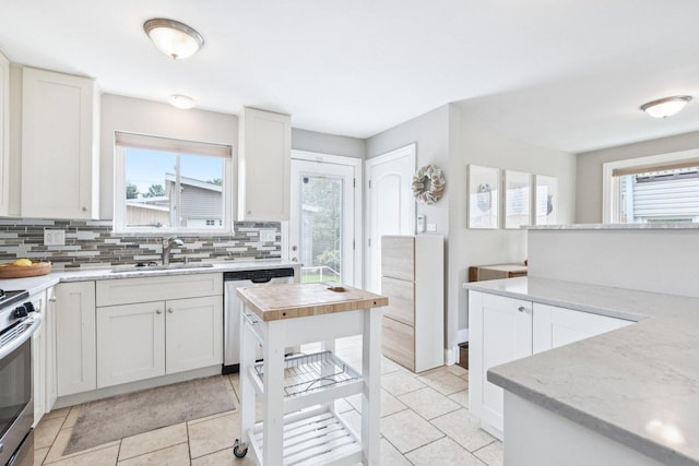 9333 Kildare Ave, Skokie, IL 60076 - kitchen featuring stainless steel appliances, backsplash, white cabinetry, and light tile patterned floors