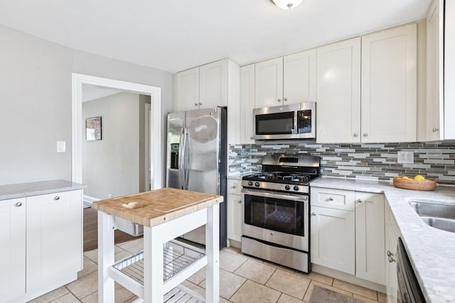 9333 Kildare Ave, Skokie, IL 60076 - kitchen with stainless steel appliances, decorative backsplash, light countertops, and light tile patterned floors