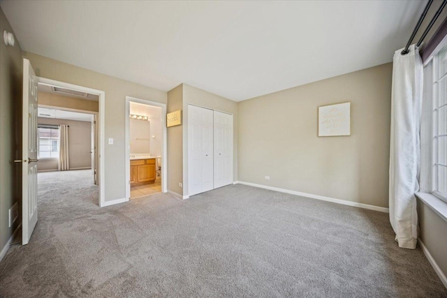 180 New Haven Dr, Cary, IL 60013 - unfurnished bedroom featuring light carpet, a closet, and connected bathroom