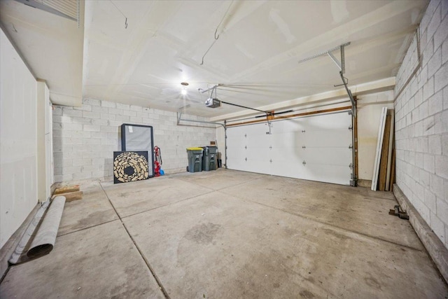 180 New Haven Dr, Cary, IL 60013 - garage featuring concrete block wall and a garage door opener