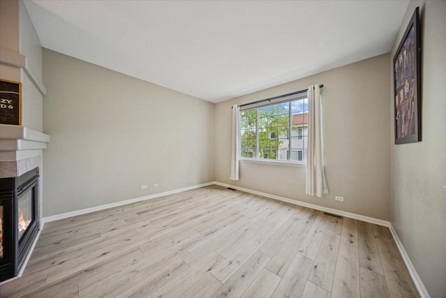 180 New Haven Dr, Cary, IL 60013 - unfurnished living room with a glass covered fireplace and wood finished floors