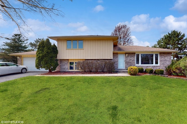 14320 S Elizabeth Ln, Homer Glen, IL 60491 - split level home featuring a garage, a front yard, brick siding, and driveway