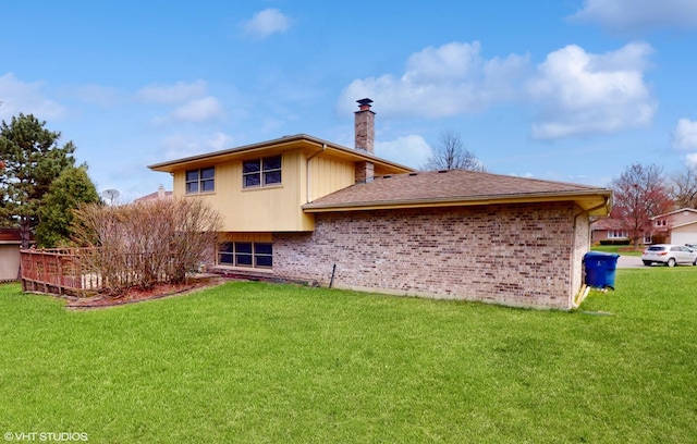 14320 S Elizabeth Ln, Homer Glen, IL 60491 - rear view of property featuring a chimney, brick siding, and a yard