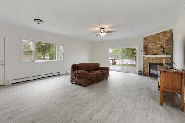 550 N Center St, South Elgin, IL 60177 - living area featuring baseboard heating, ceiling fan, healthy amount of natural light, a fireplace, and crown molding