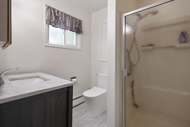 550 N Center St, South Elgin, IL 60177 - full bathroom with a stall shower, vanity, baseboard heating, and wood finished floors