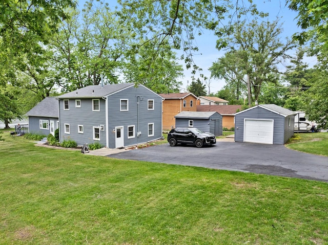 550 N Center St, South Elgin, IL 60177 - view of front of house featuring an outdoor structure, a garage, a front yard, and asphalt driveway