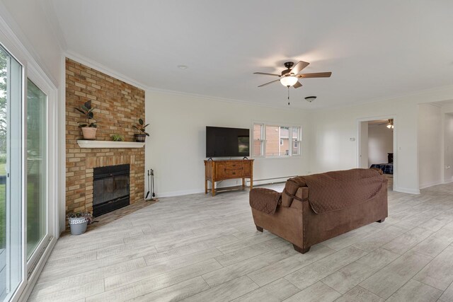550 N Center St, South Elgin, IL 60177 - living room featuring a ceiling fan, light wood-style flooring, crown molding, and a fireplace