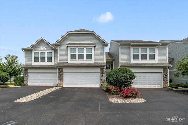 114 Devoe Dr N, Oswego, IL 60543 - view of front of house featuring stone siding, driveway, and a garage