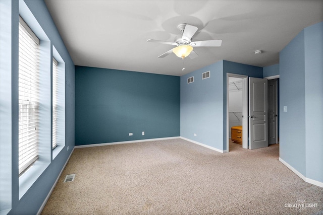 114 Devoe Dr N, Oswego, IL 60543 - unfurnished bedroom with multiple windows, a spacious closet, and carpet