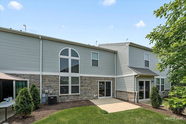 114 Devoe Dr N, Oswego, IL 60543 - rear view of property featuring stone siding, a patio, and a yard